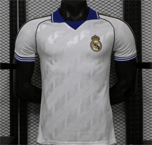 Real Madrid white home jersey with blue collar and jacquard pattern, front view
