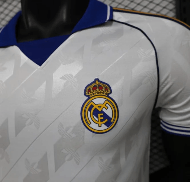Close-up of Real Madrid crest on white jersey with jacquard pattern