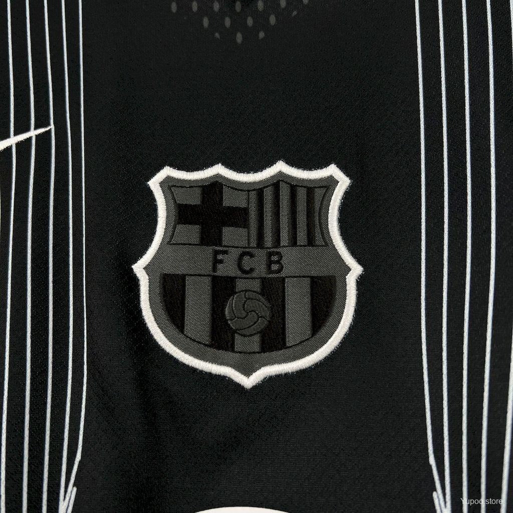 Close-up of Barcelona crest embroidery on black jersey, sports fan accessory