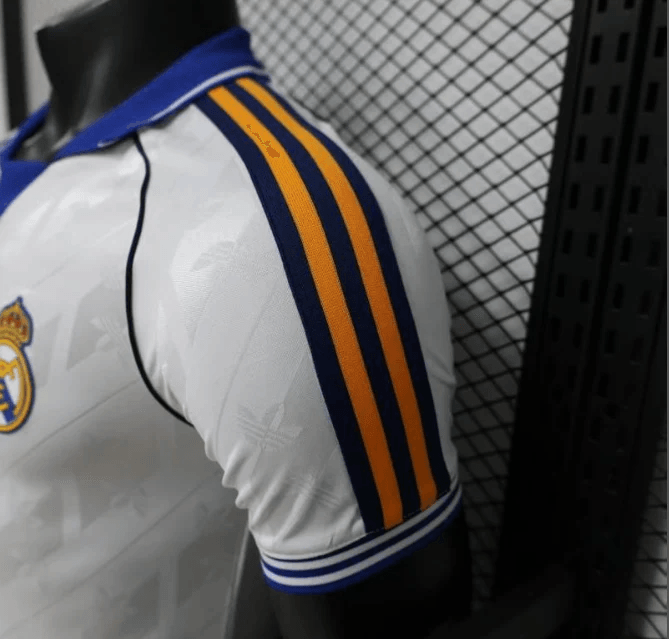 Shoulder detail of Real Madrid jersey with blue and yellow stripes