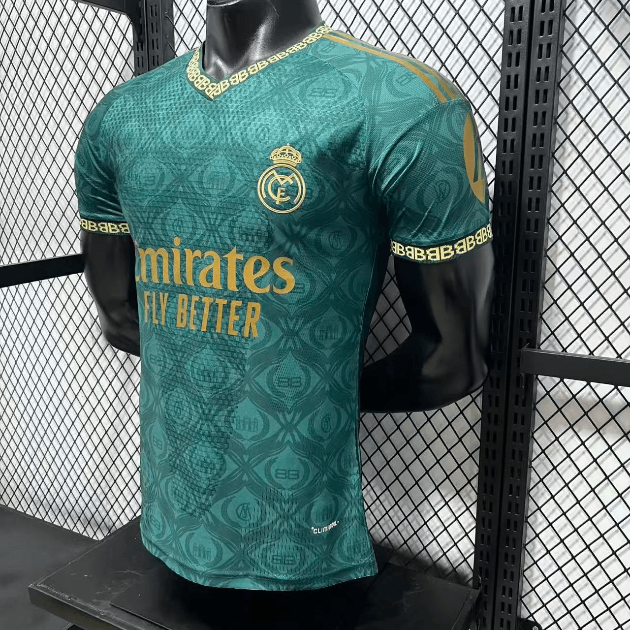 Close-up of embroidered crest on teal Real Madrid jersey